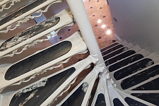 Iron staircase with inserts made of natural stone
