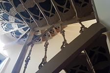 Iron staircase with inserts made of natural stone