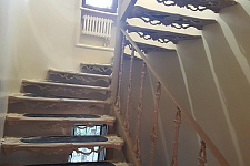 Iron staircase with inserts made of natural stone